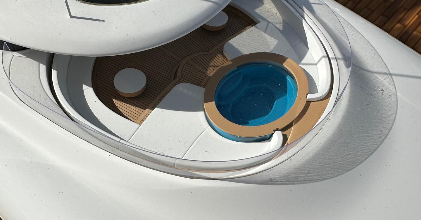 Superyacht Breakthrough upper deck jacuzzi and white sunpads 