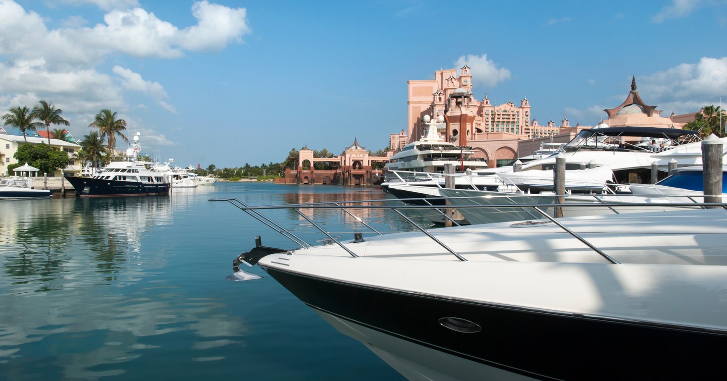 Sea level view of a Paradise Island, Nassau marina. Atlantis Resort in background, with superyachts moored in foreground