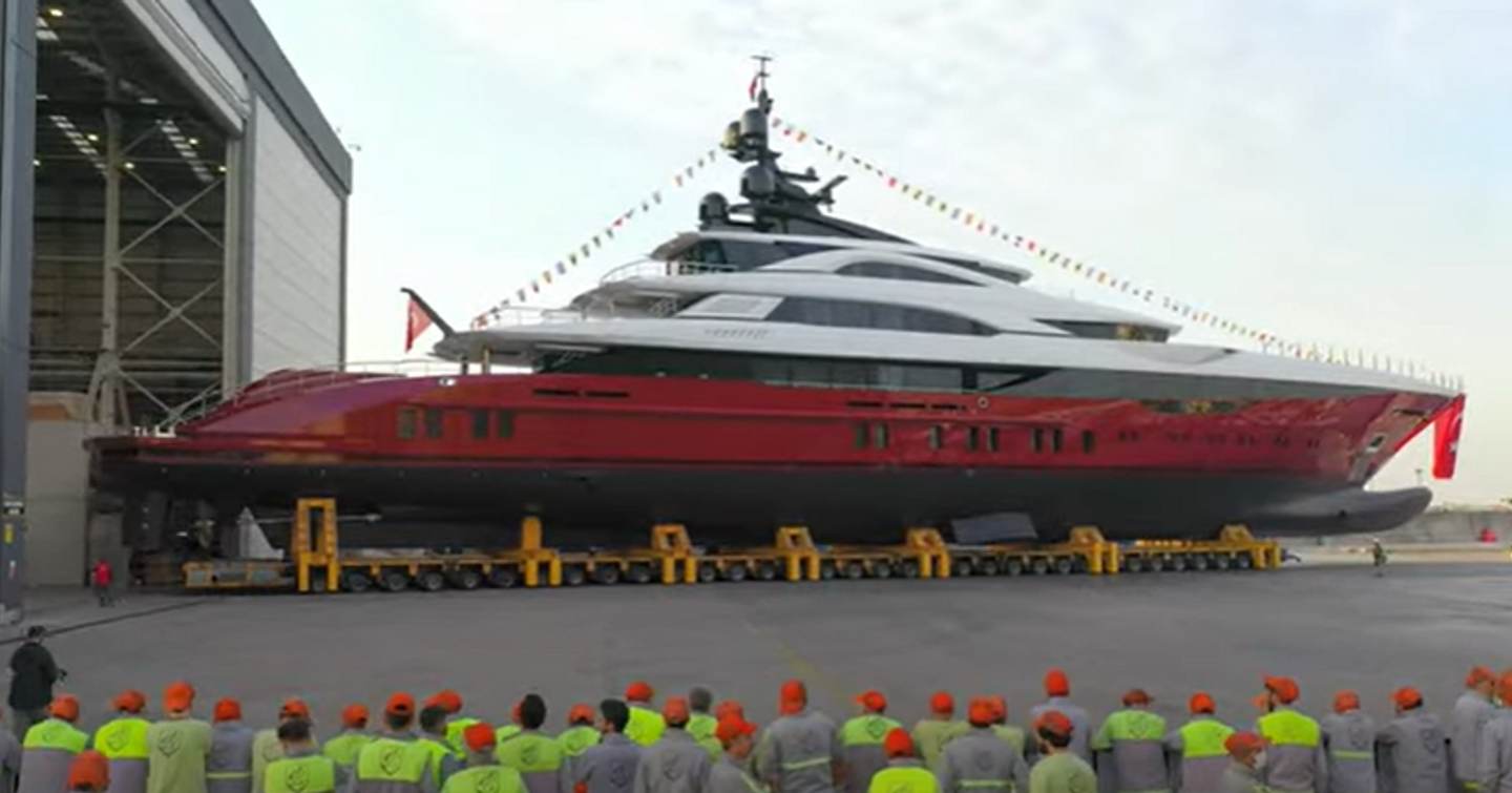 Bilgin superyacht LEONA in transit from shed to water. With team members in hard hats watching proceedings.