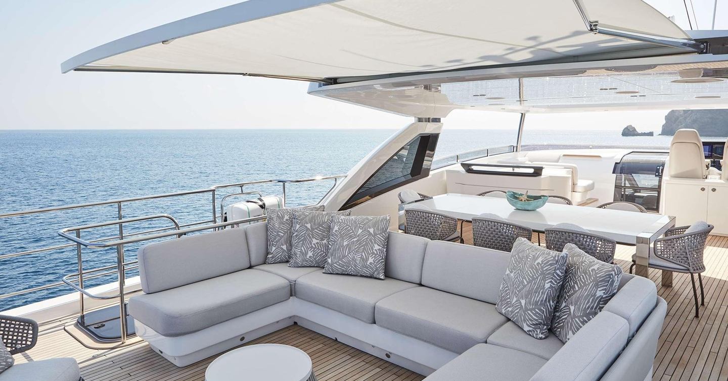 Motor yacht Ghost's upper deck with U-shaped shaded seating