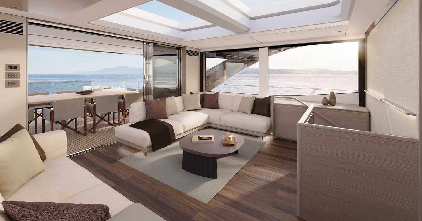 Main saloon on motor yacht X90, with L shaped white sofa and abundant glass 