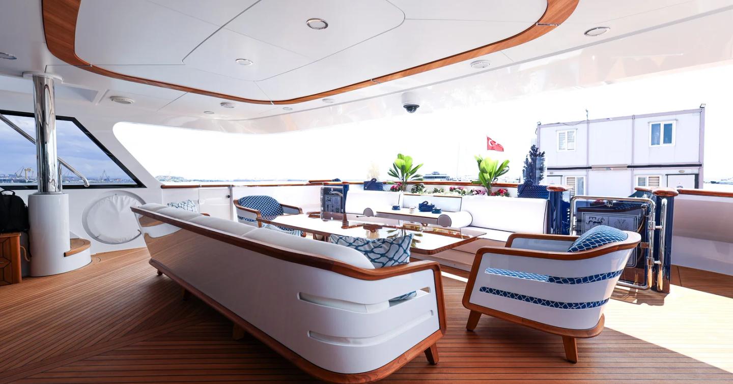 Trinity Superyacht Mirabella main deck with white sofa and wooden coffee table post refit 