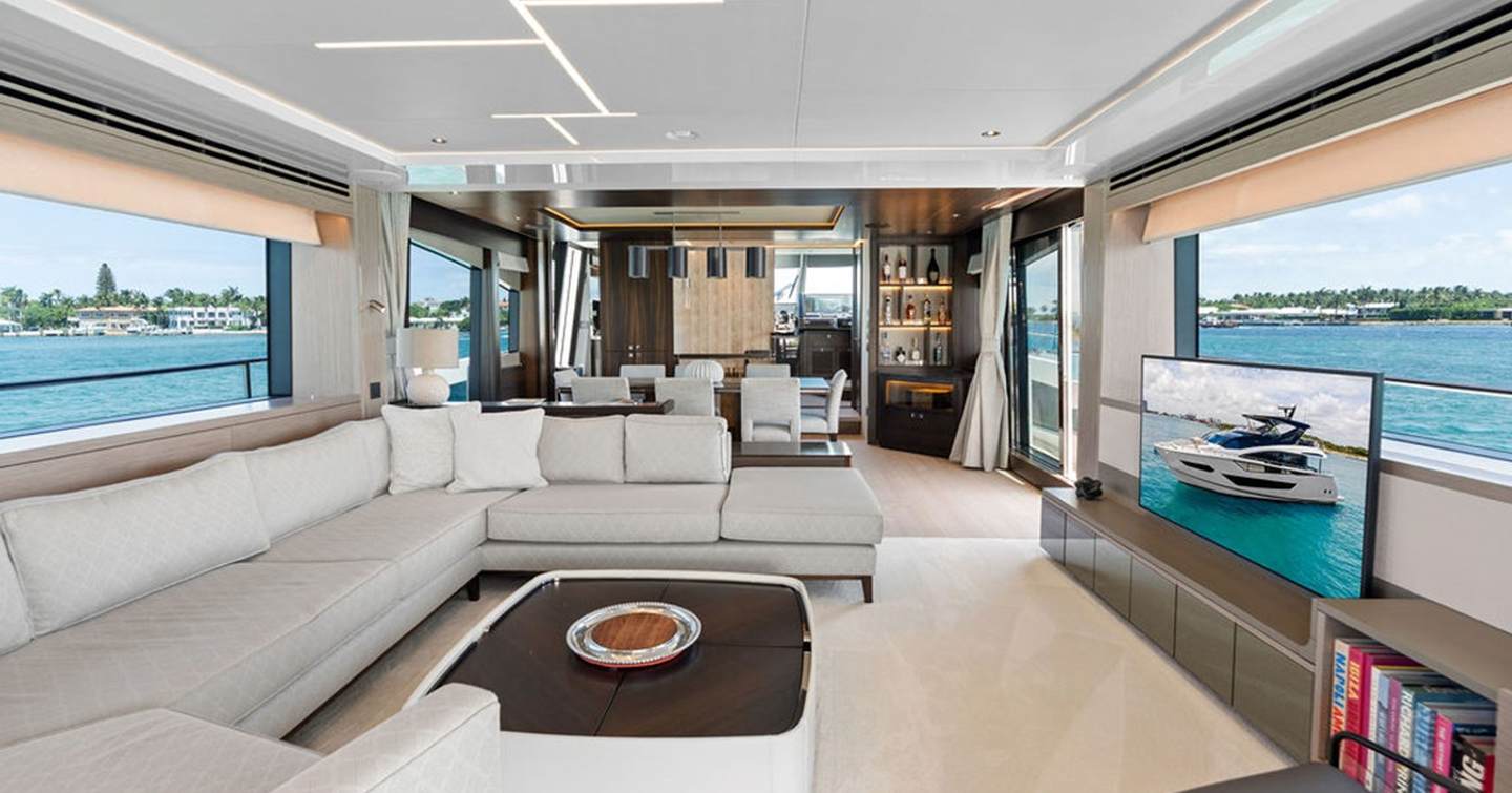 Motor yacht Dolce Far Niente main saloon with L-shaped grey sofa