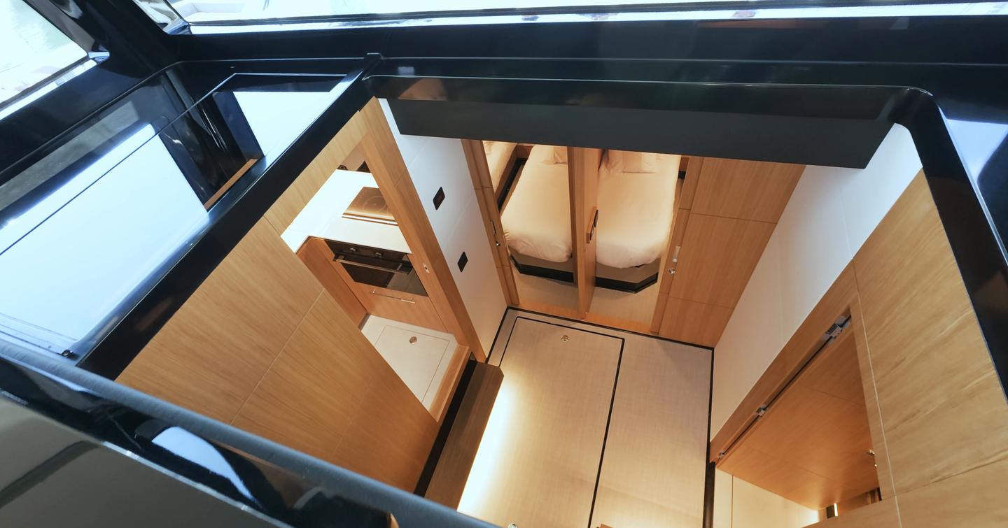 De Antonio D60 lower deck atrium showing bright central accommodation space and guest cabin access