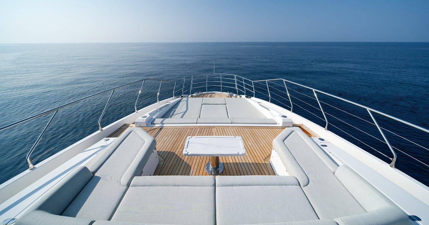 Motor yacht Chillin' foredeck with U-shaped seating and sunpads