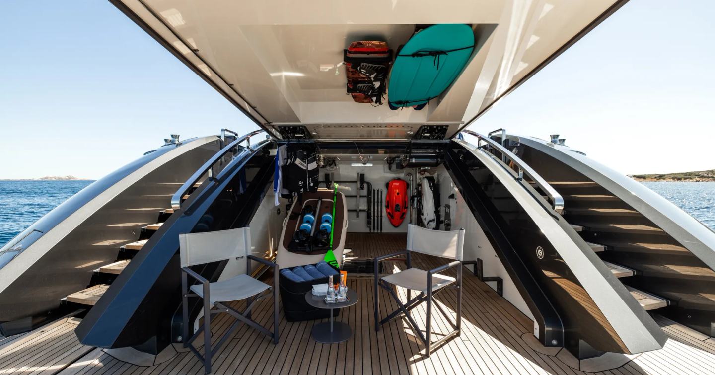 Superyacht Flying Dagger III hydraulic stern with deck chairs and stored tenders 