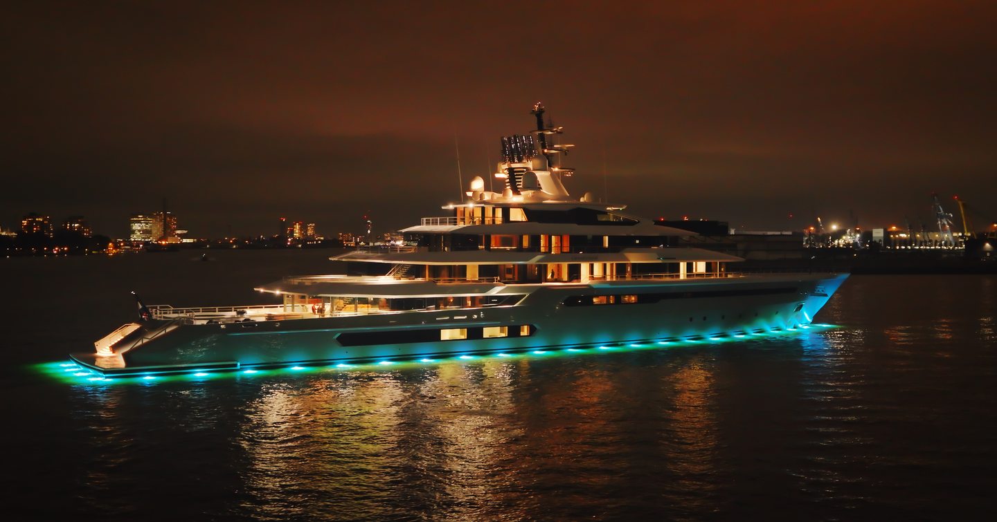 Superyacht Leviathan at anchor at night with underwater lights 