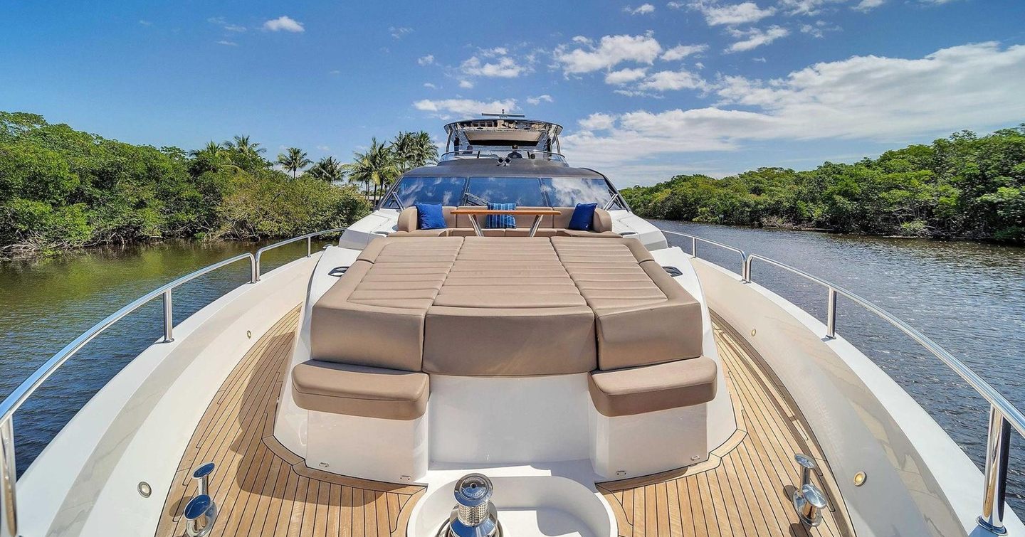 Motor Yacht Aqua Vista foredeck with sunpads and wooden table