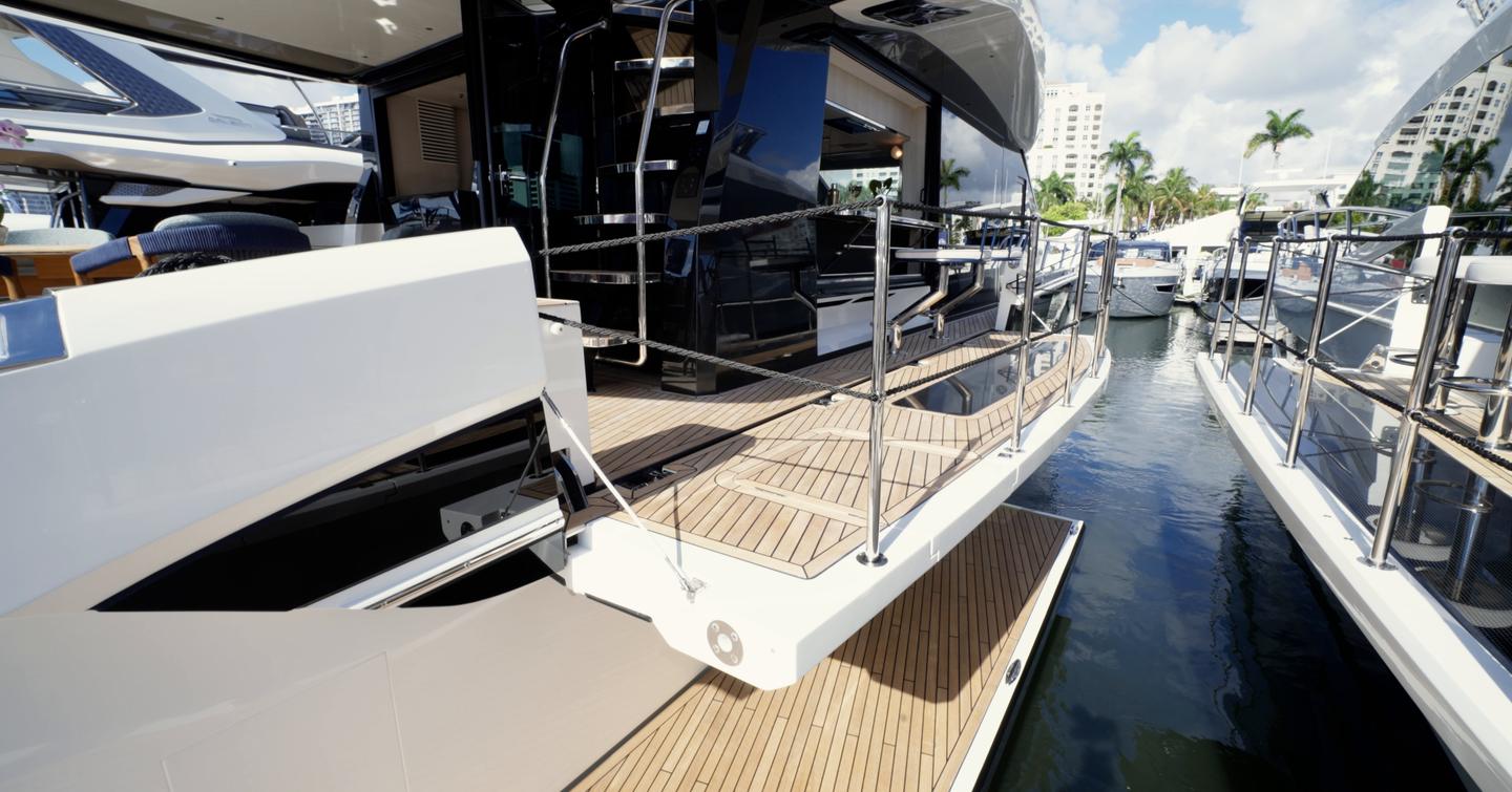 Side deck aboard the Galeon 620 Fly with fold-down platform deployed beside the water.