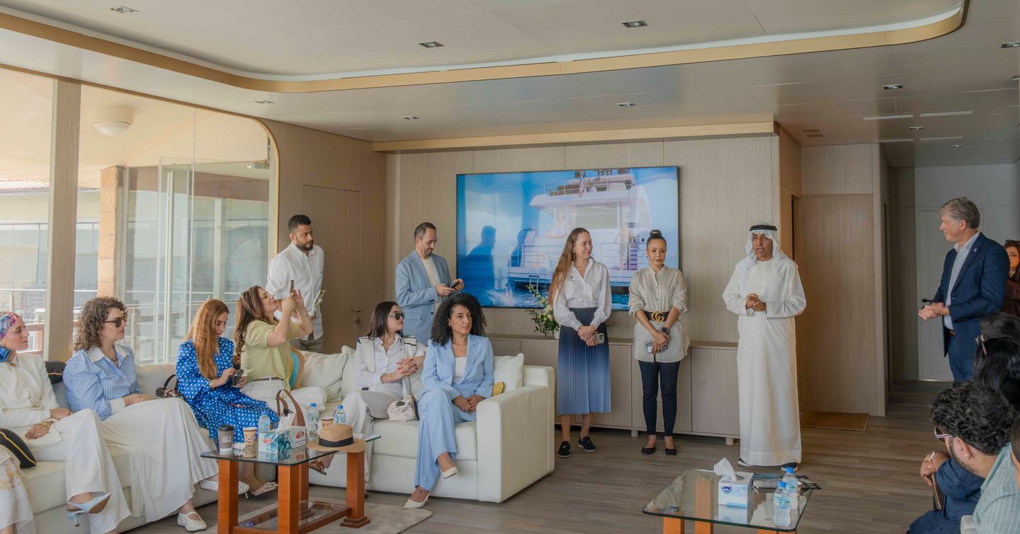 Journalists and visitors in main saloon of Gulf Craft Majesty 145 Superyacht Suzie Q