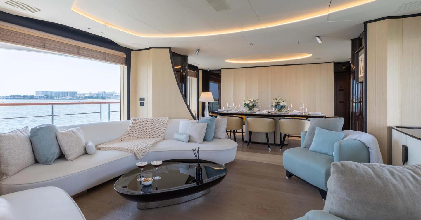 Superyacht Bella Vita main saloon with curved blue and white sofas 
