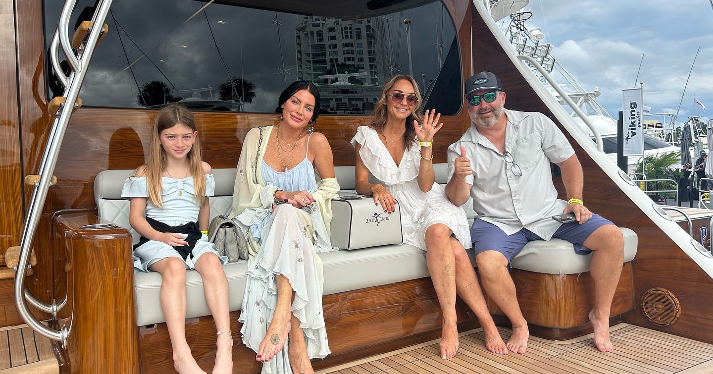 Happy family onboard a Viking sportfisher during boat show