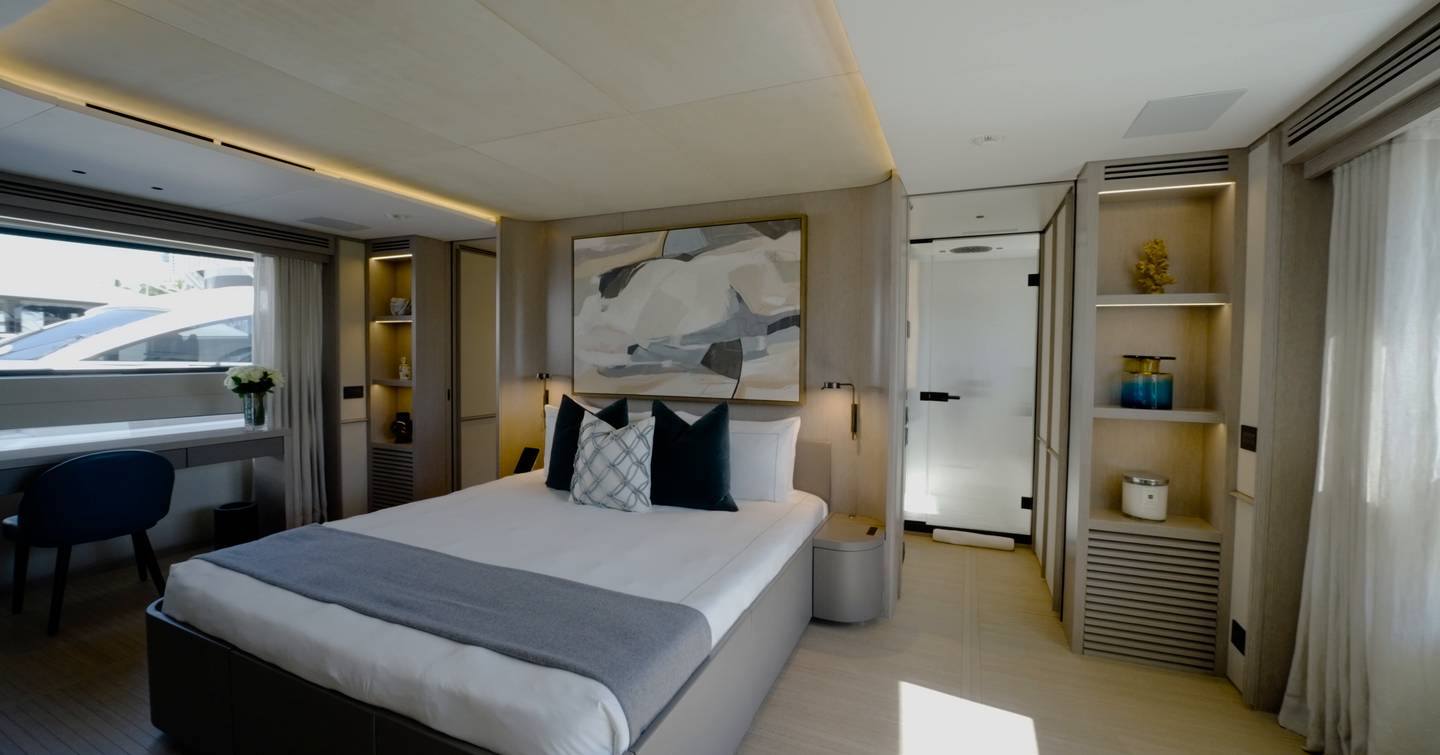 Benetti Oasis 34M main-deck owner's suite with king-size bed, desk area and ensuite bathroom.