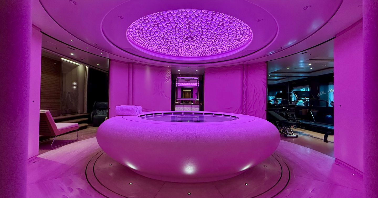 Spa and wellness centre on the Amels 242 Casino Royale featuring a central pool with gym and relaxation areas.