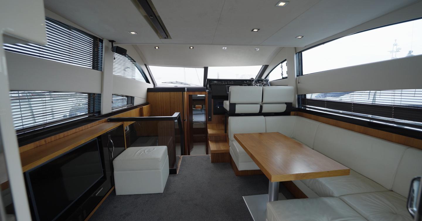 Fairline Squadron 42 main saloon showing dinette and forward helm station