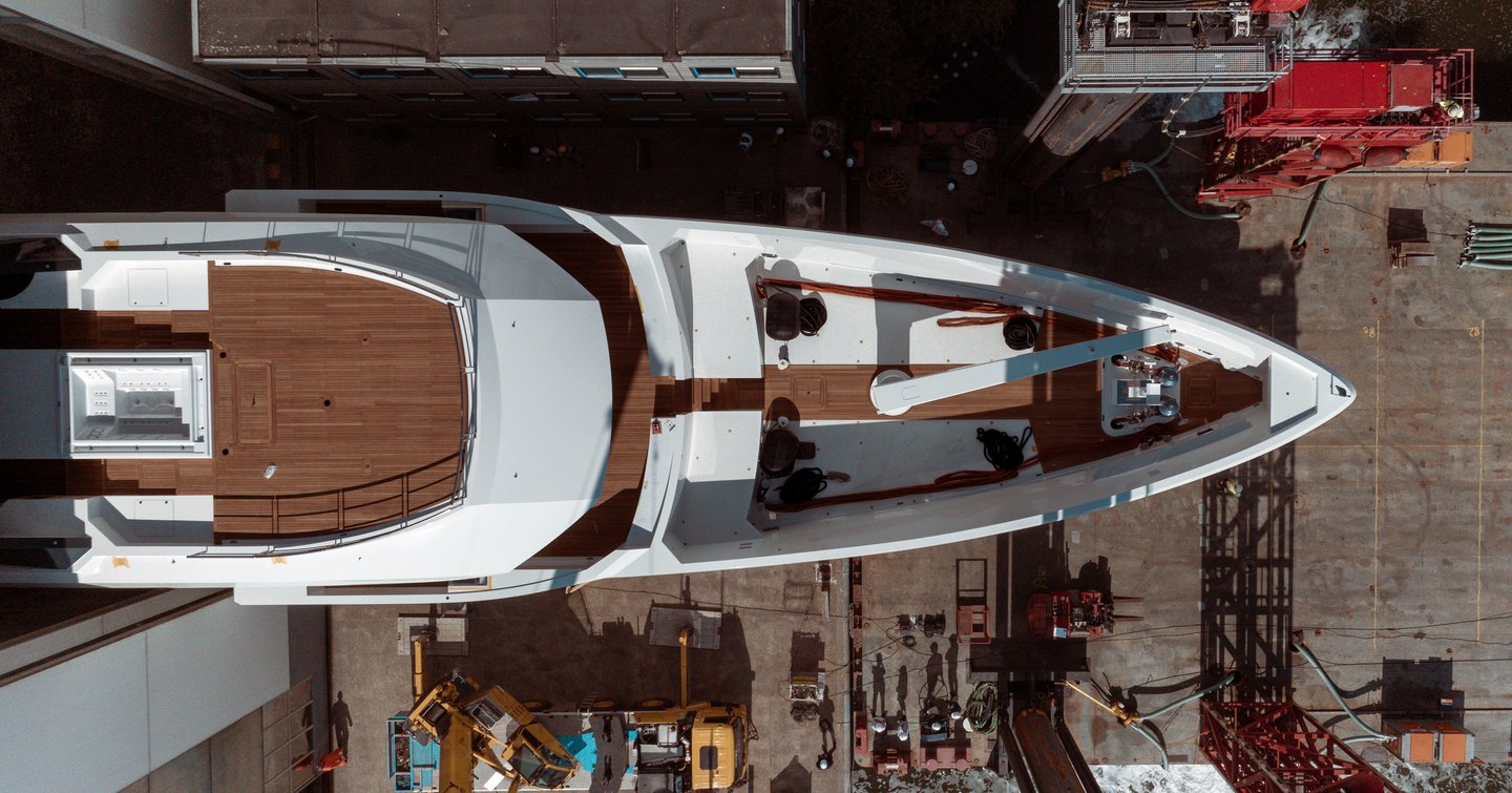 Aerial view looking down on the fourth Amels 60 emerging from shed.