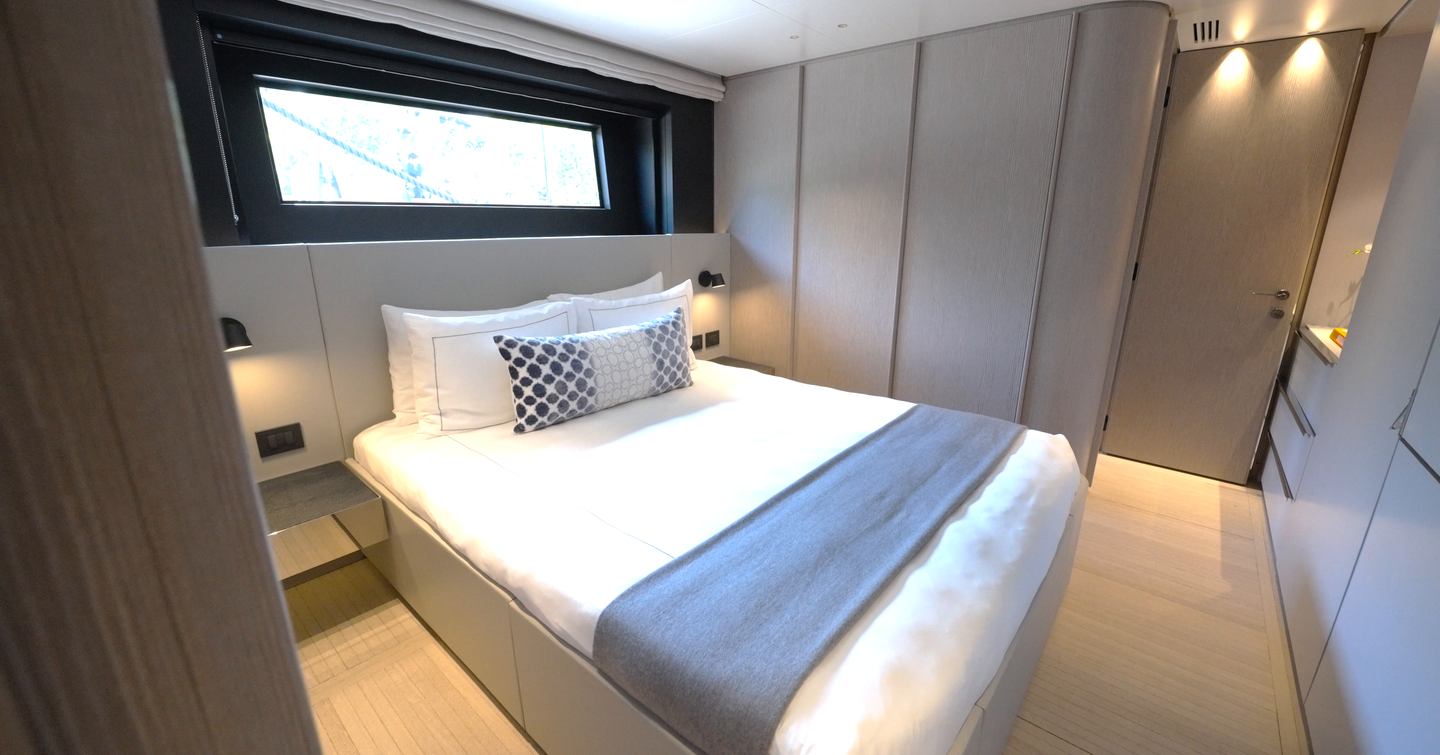 Benetti Oasis 34M double guest cabin with island berth, hull-side glazing and ensuite bathroom.