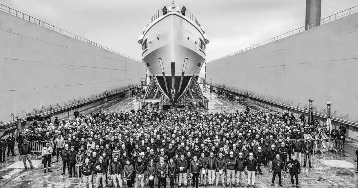 Superyacht workers underneath bow of superyacht 