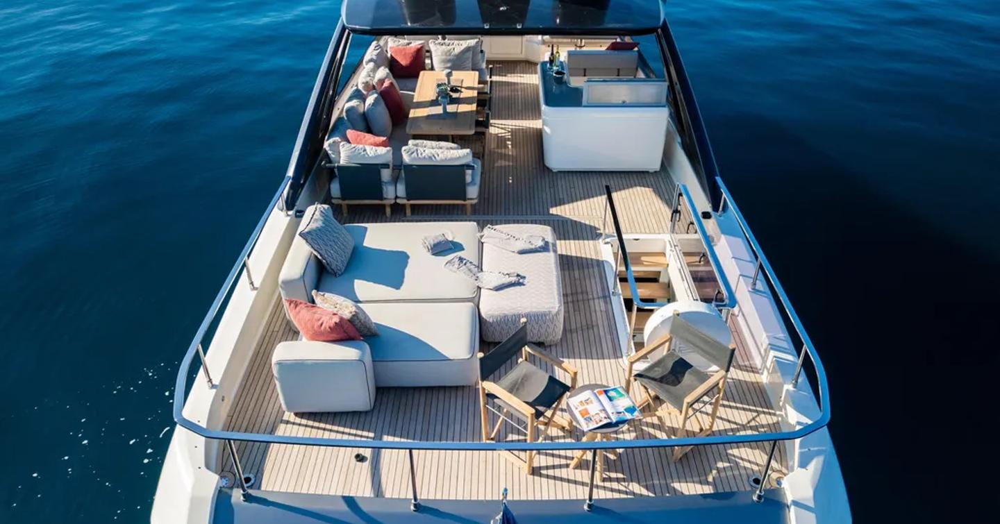 Motor Yacht Dogu flybridge with sunpads and shaded seating and bar area 