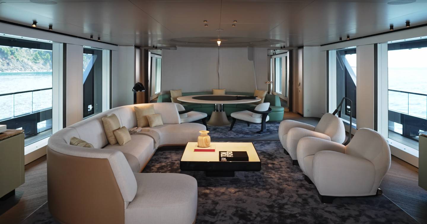 Explorer Yacht RJ main saloon with cream curved seating and circular dining table 