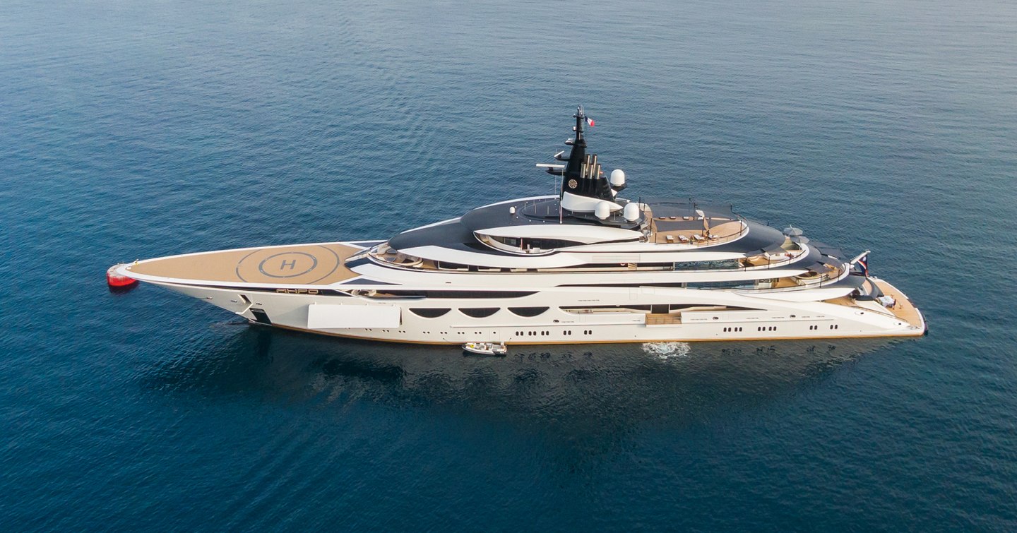 Side view of megayacht AHPO underway, surrounded by sea.