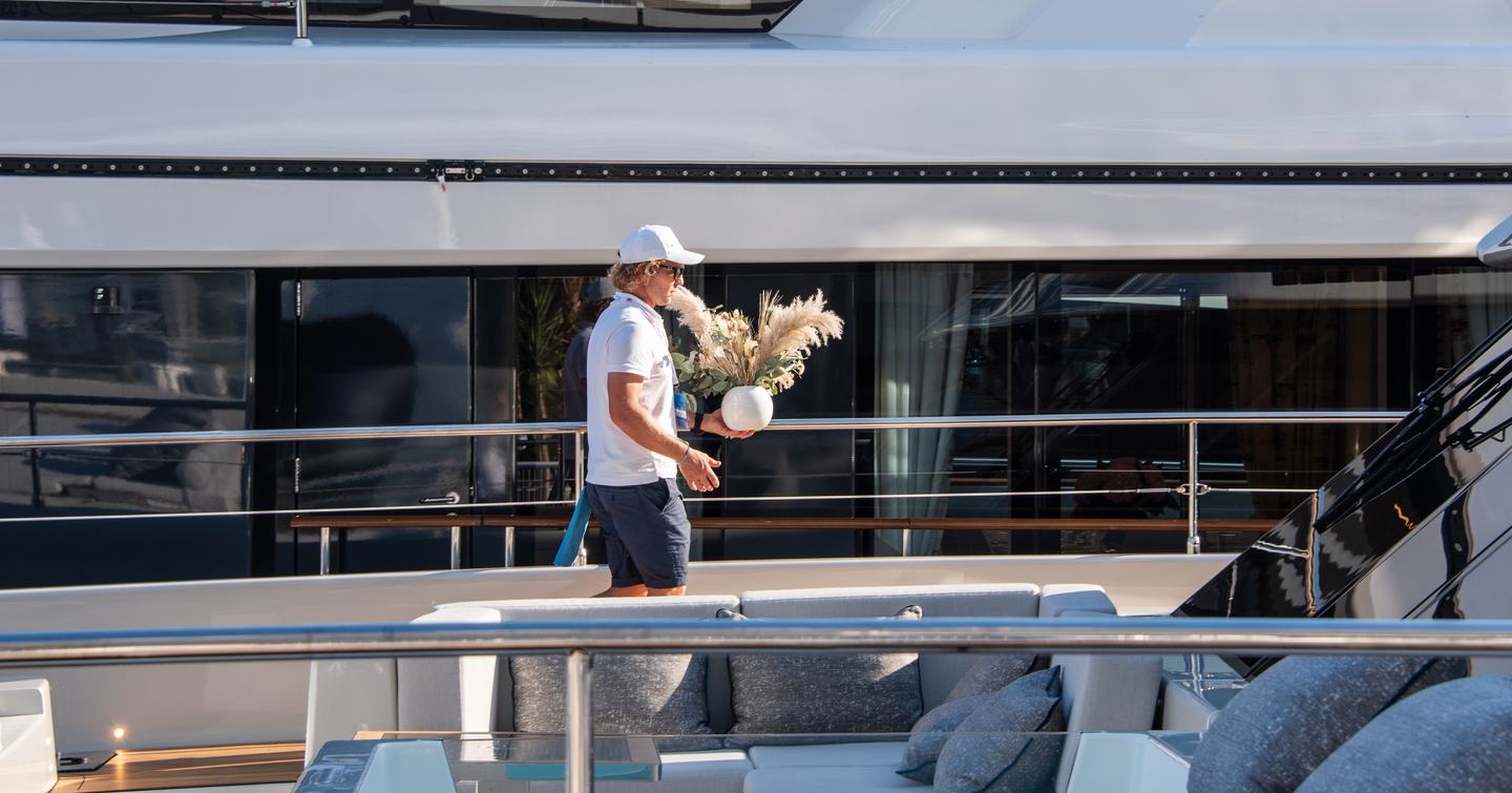 superyacht crew carrying flowers