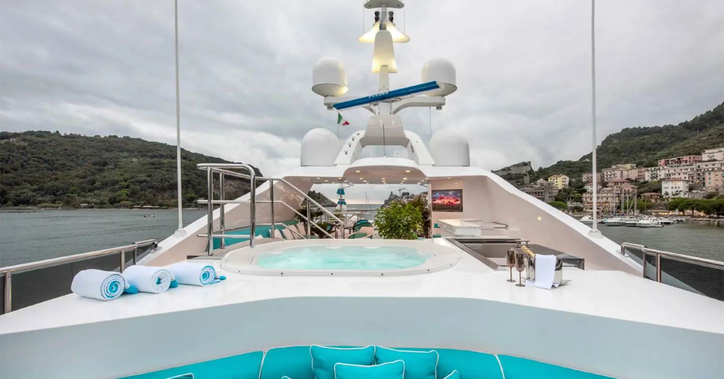 Superyacht Rhino upper deck with jacuzzi and blue sunpads 