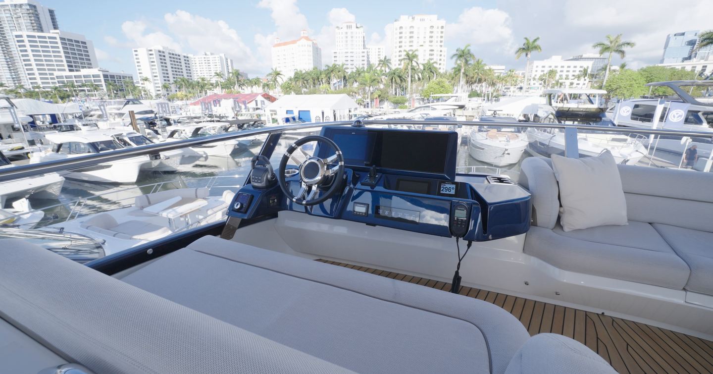 Upper flybridge helm station aboard the Galeon 620 Fly with twin displays and wraparound seating.