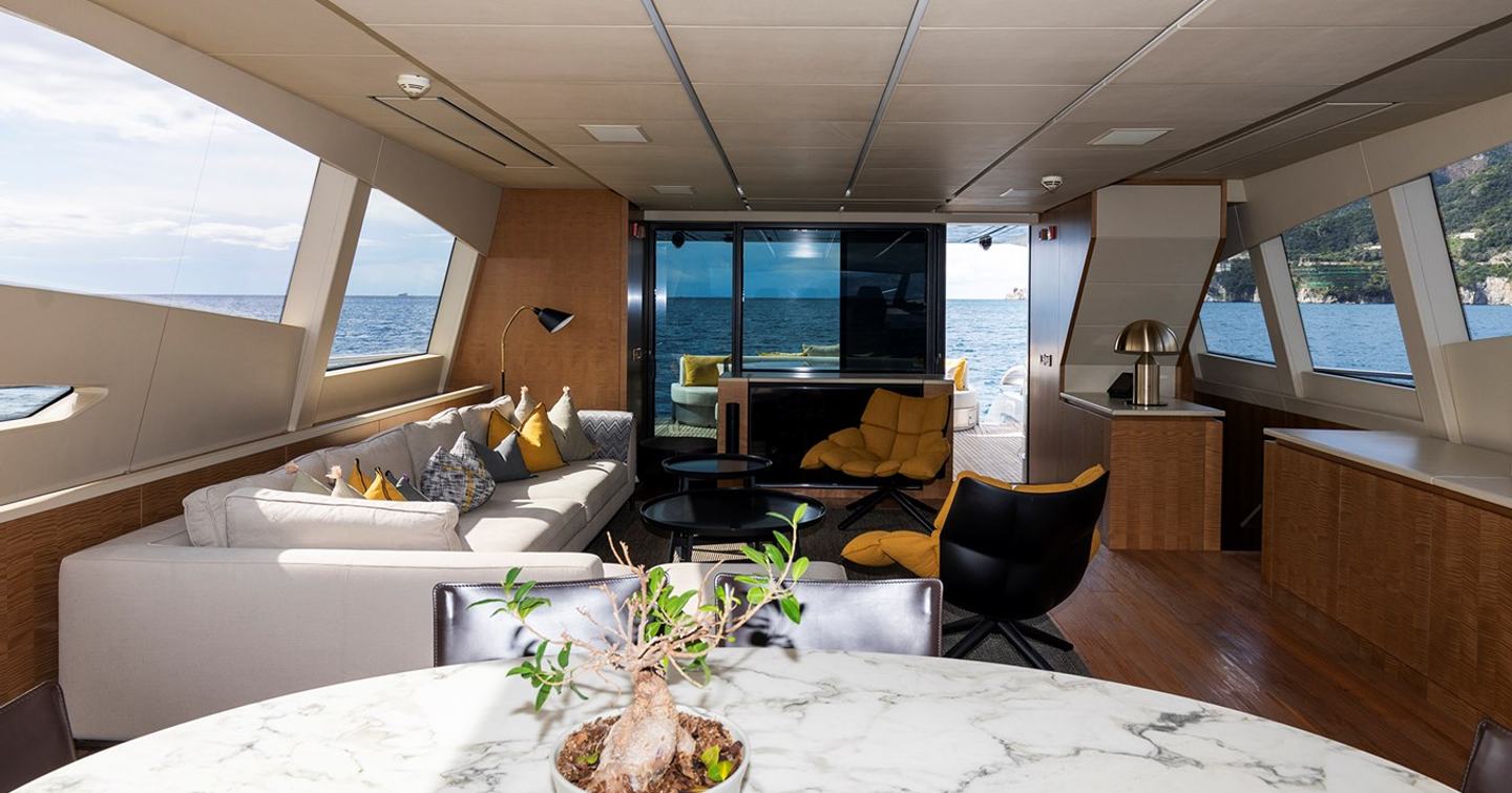 Pershing 108 superyacht Grace  main salon with L-shaped white sofa 