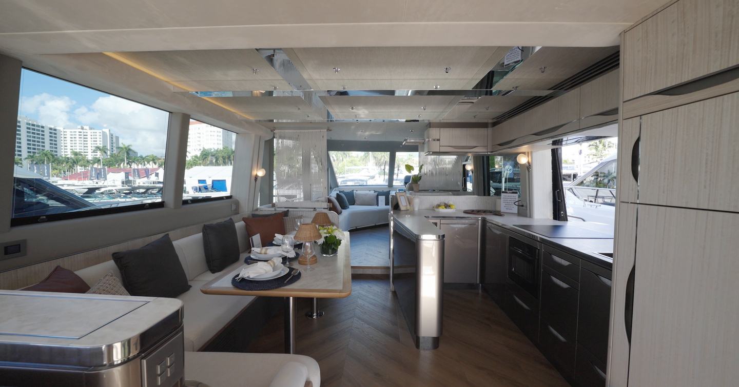 Main deck saloon and galley aboard the Galeon 620 Fly with asymmetrical layout and large side glazing.
