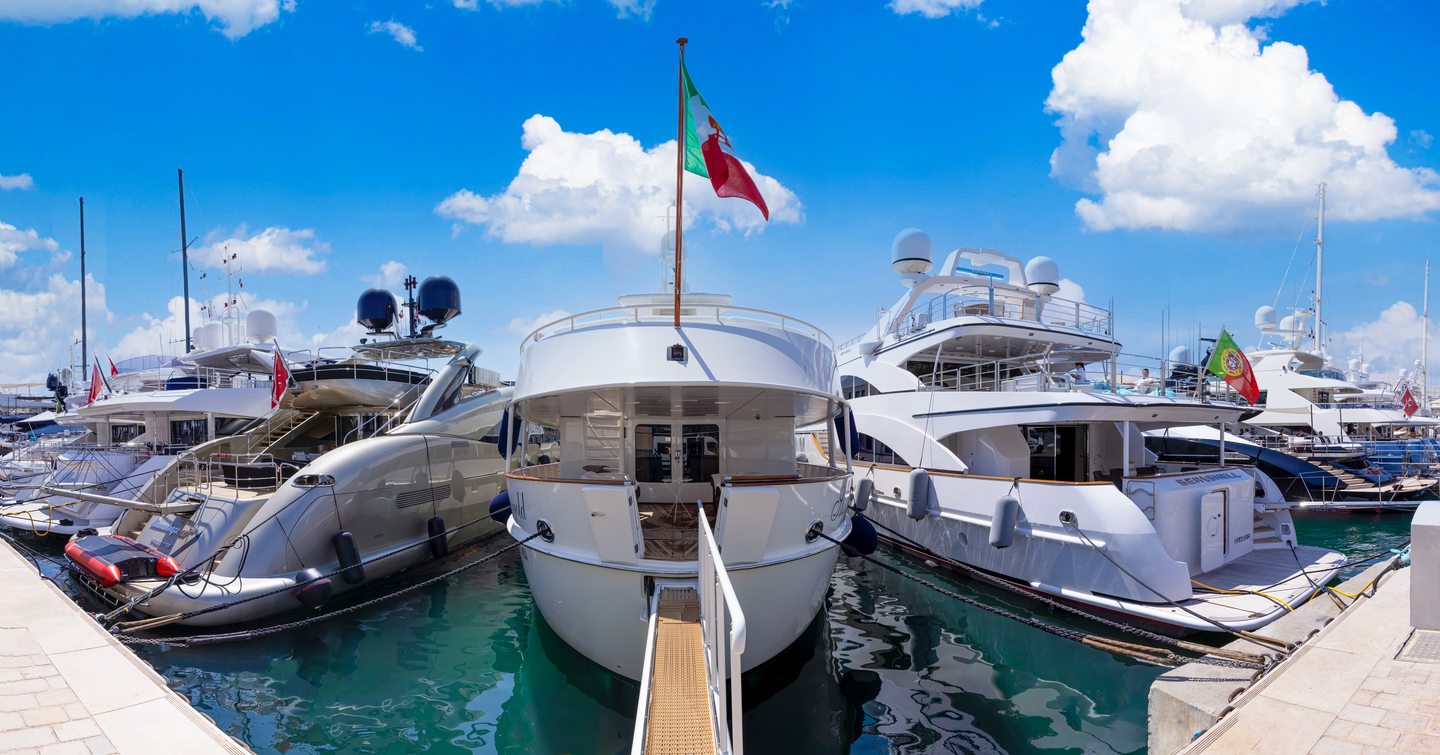 Panoramic image of motor yachts aft decks, berthed at Cannes Yachting Festival.