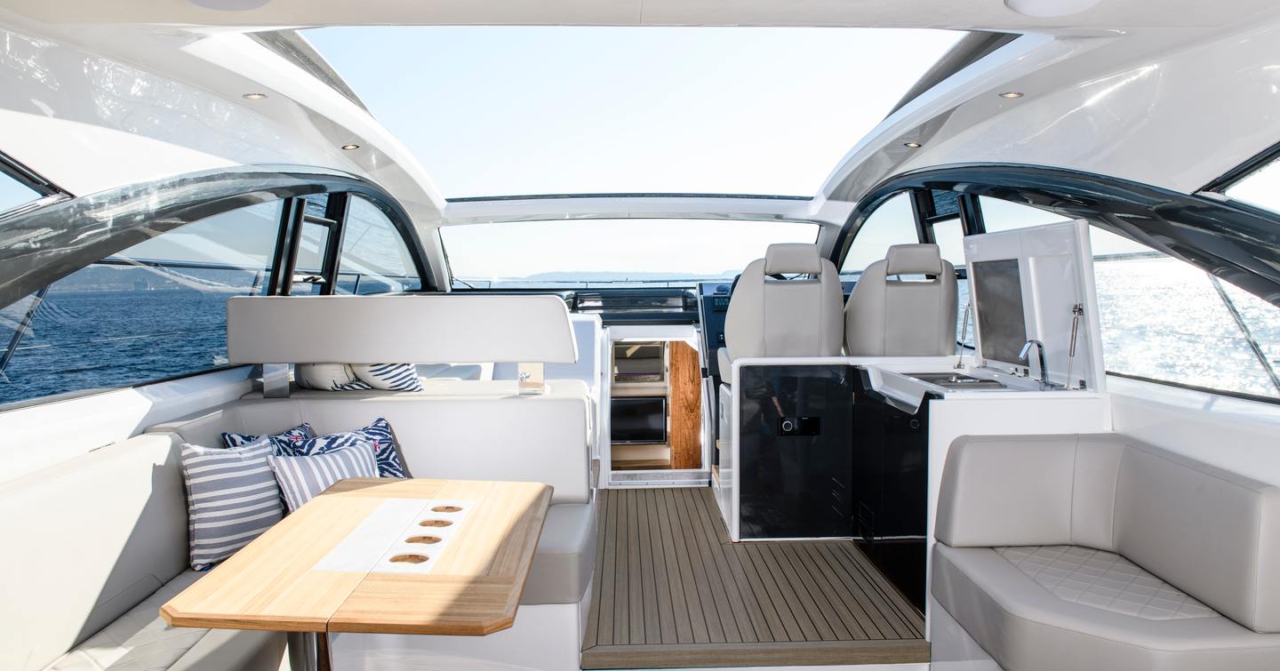 built-in seating and a coffee table in the cockpit of the Targa 45 with a open hard-top above