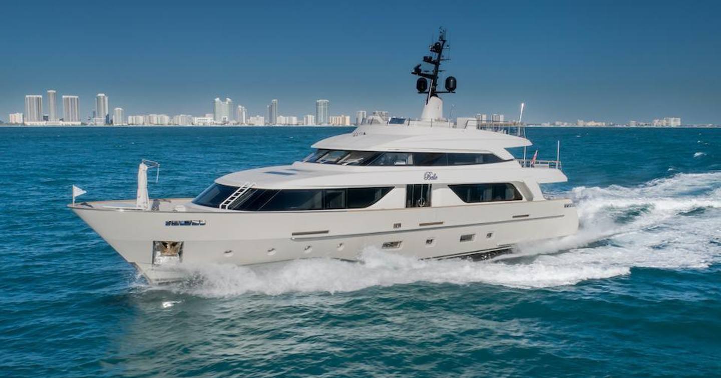 Motor yacht Phoenix underway, with the cityscape in the background 