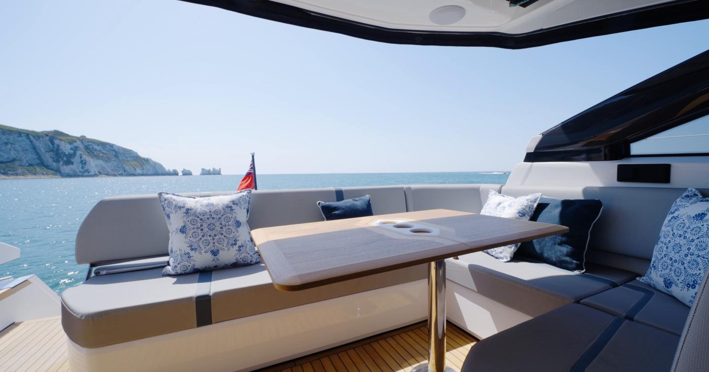Cockpit dining area on the Fairline Targa 47 GT with L-shaped seating and folding table