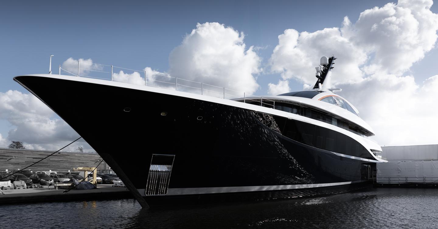 Close up of Superyacht Project 714's bow emerging from Feadship's shipyard