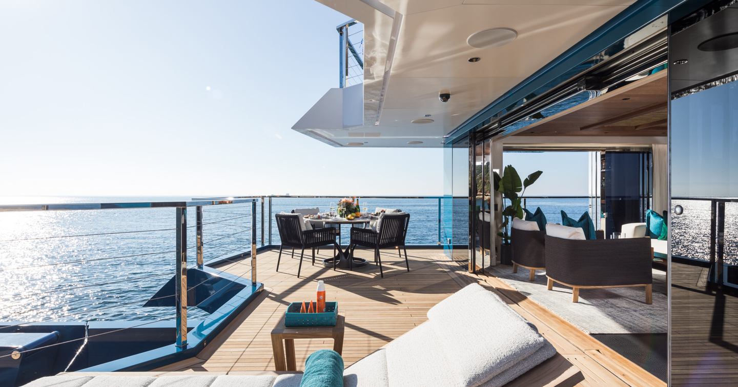 Expedition Yacht King Benji side with sun loungers and glass sliding doors 