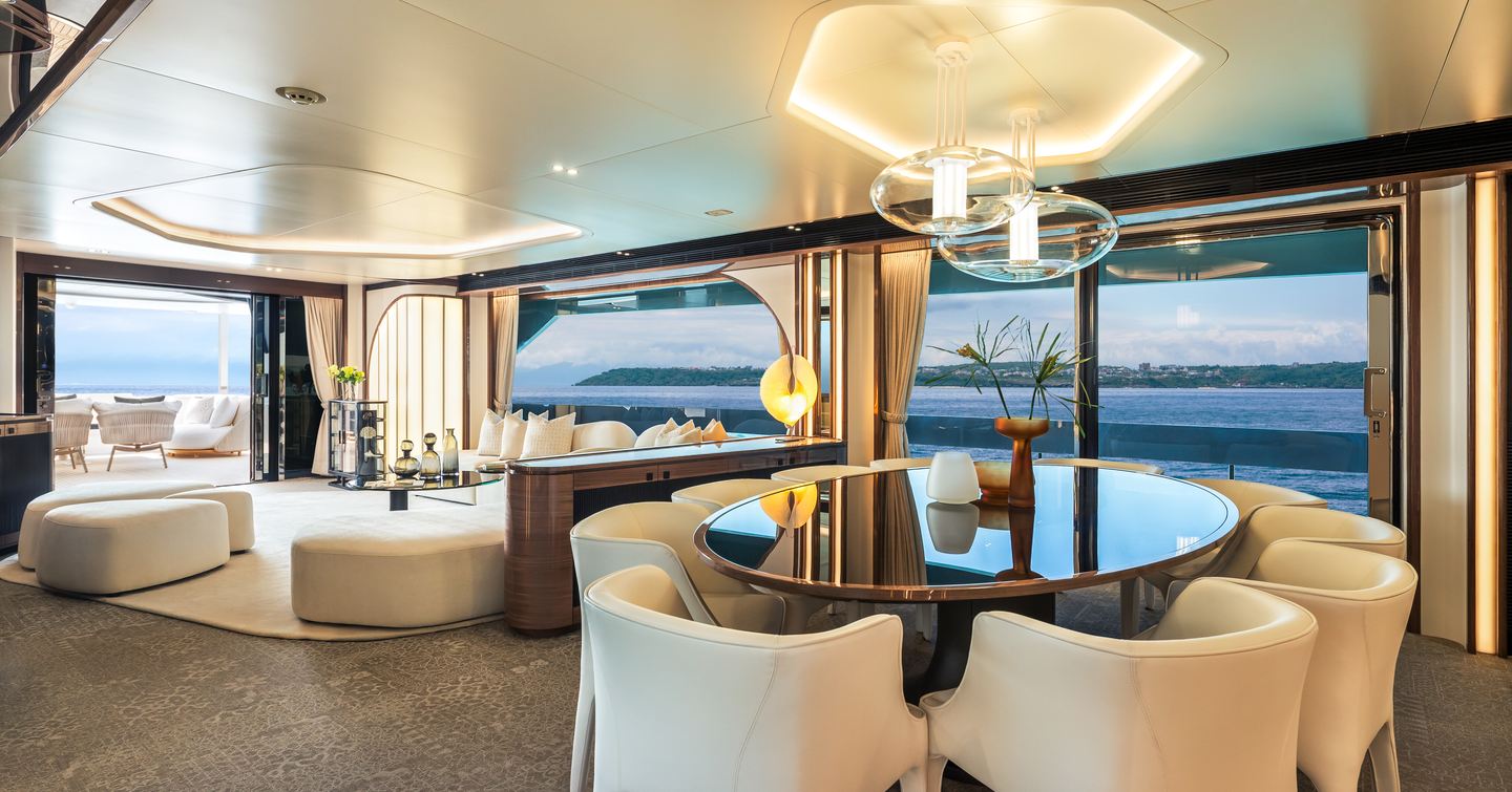 Horizon FD100 Skyline motor yacht saloon dining area with white dining chairs and abstract overhead lighting