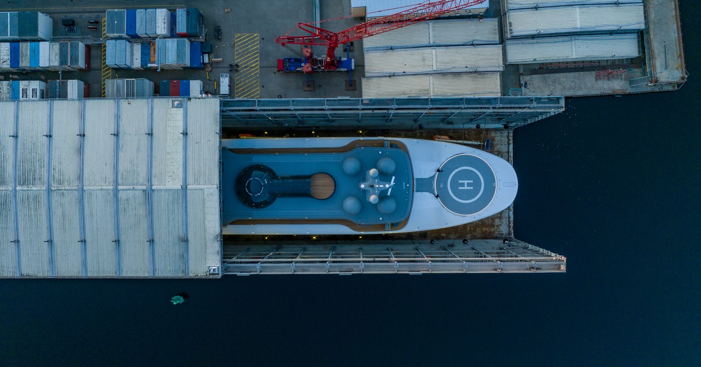 Hero shot of superyacht Project Cosmos foredecks with helipad at Lurssen shed