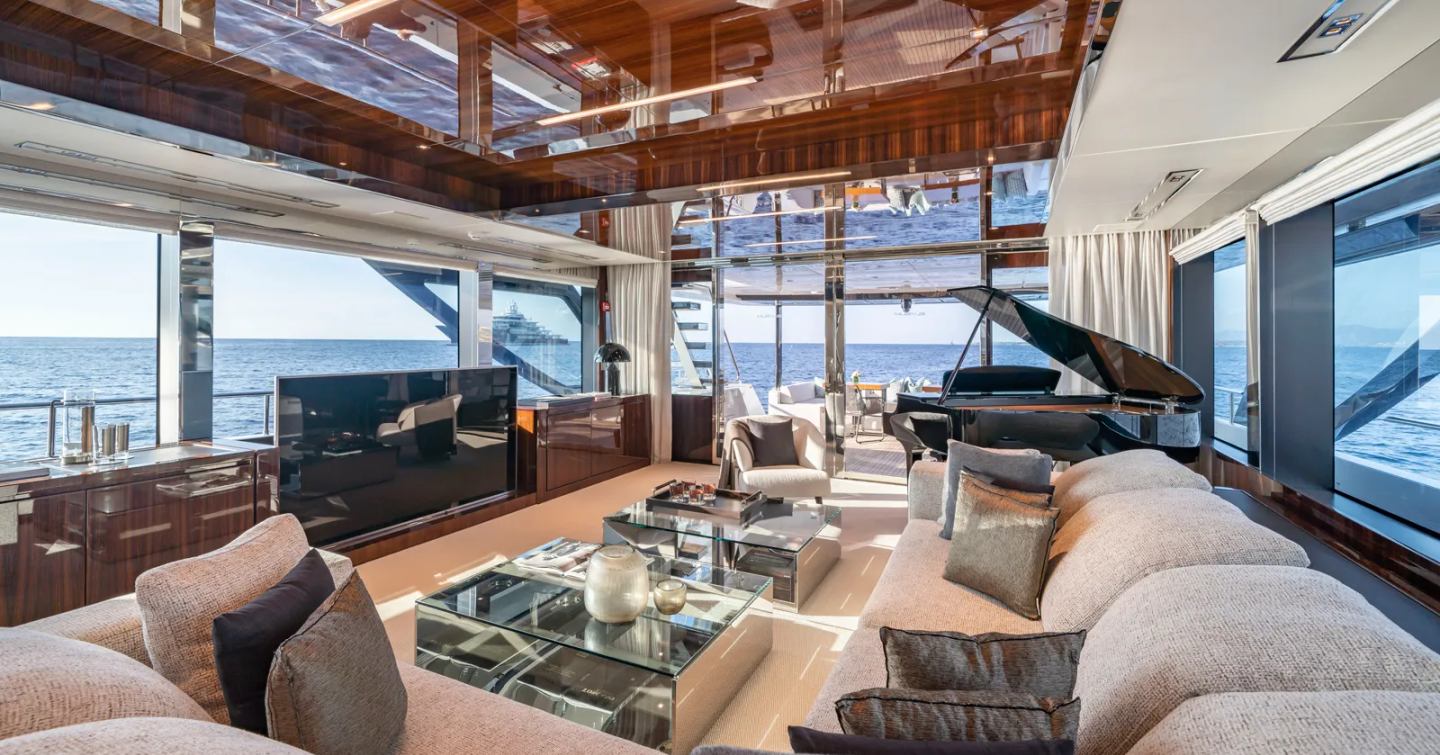 Superyacht Elysium I main saloon with L-shaped seating and grand piano