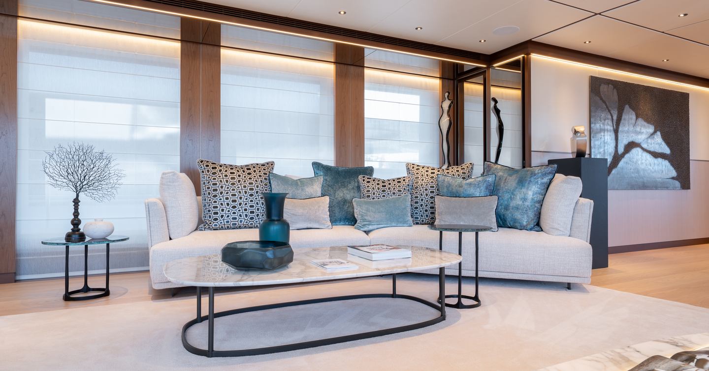 Superyacht Agnetha saloon with white sofa and blue accented cushions