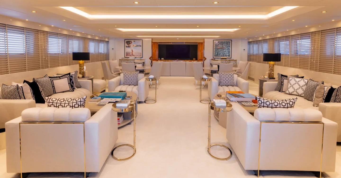 Superyacht Adamas V main saloon with parallel white furniture