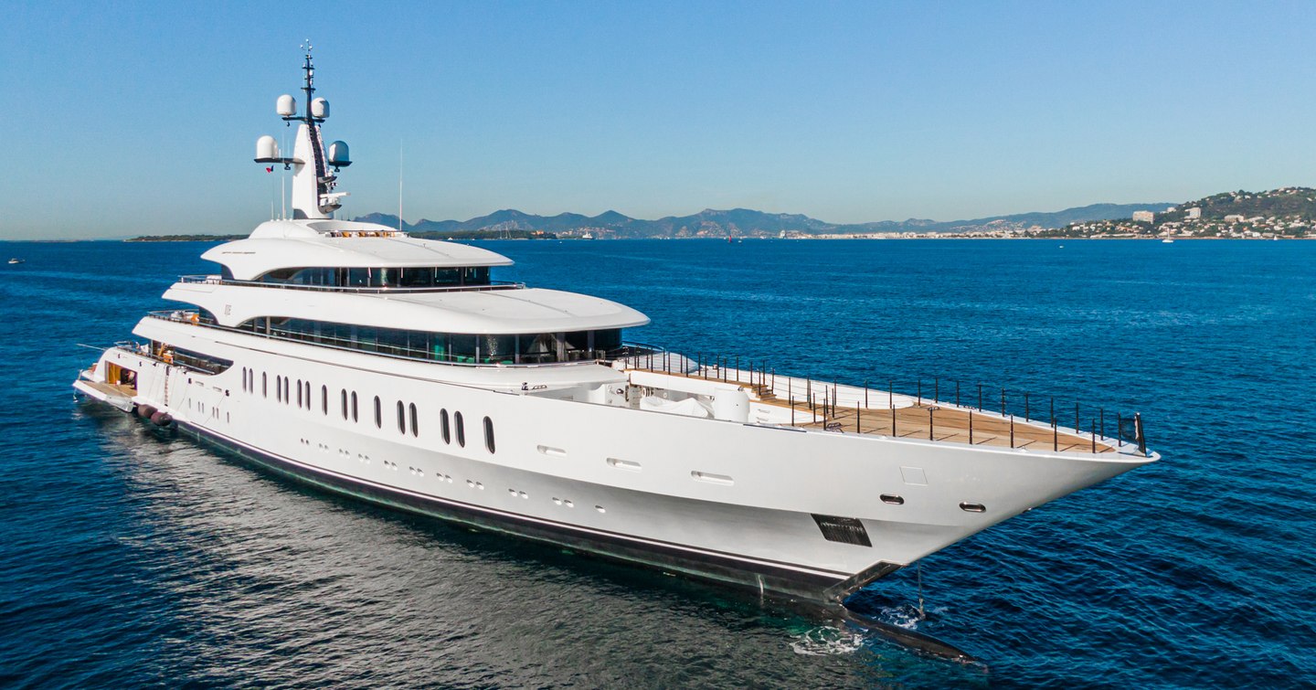 Megayacht IJE underway, surrounded by sea.