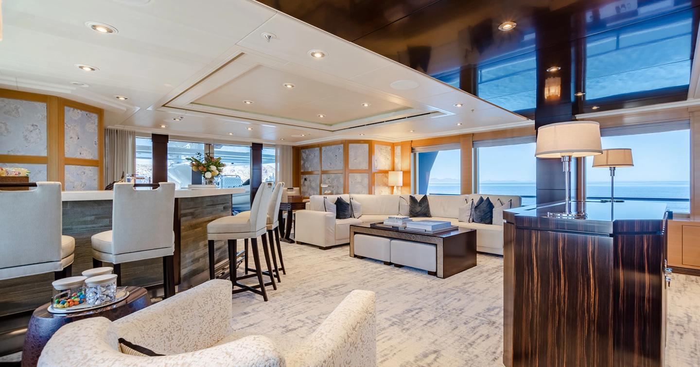 Superyacht Rochade main saloon with bar area and L-shaped sofa