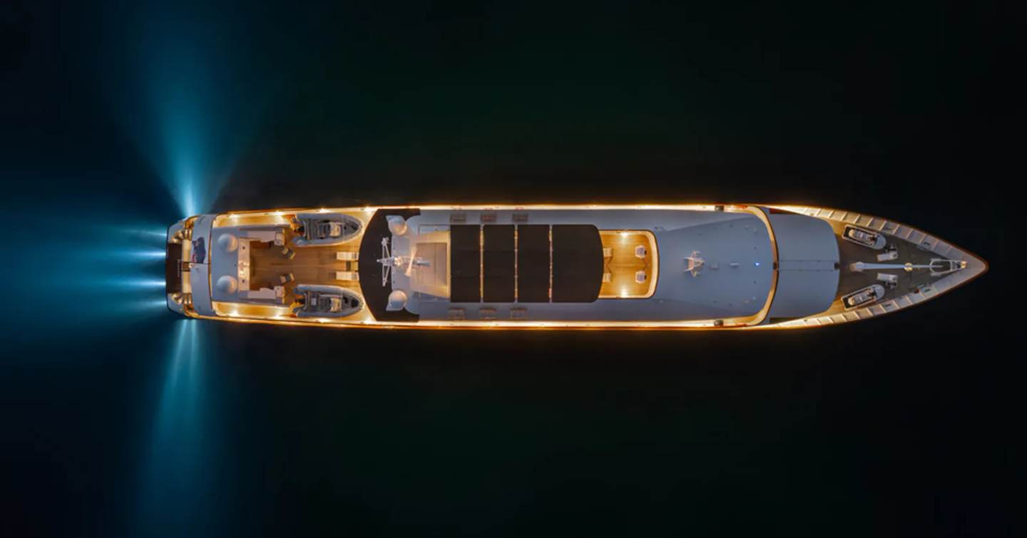 Aerial view of Superyacht Adamas V at anchor at night with underwater aft lights