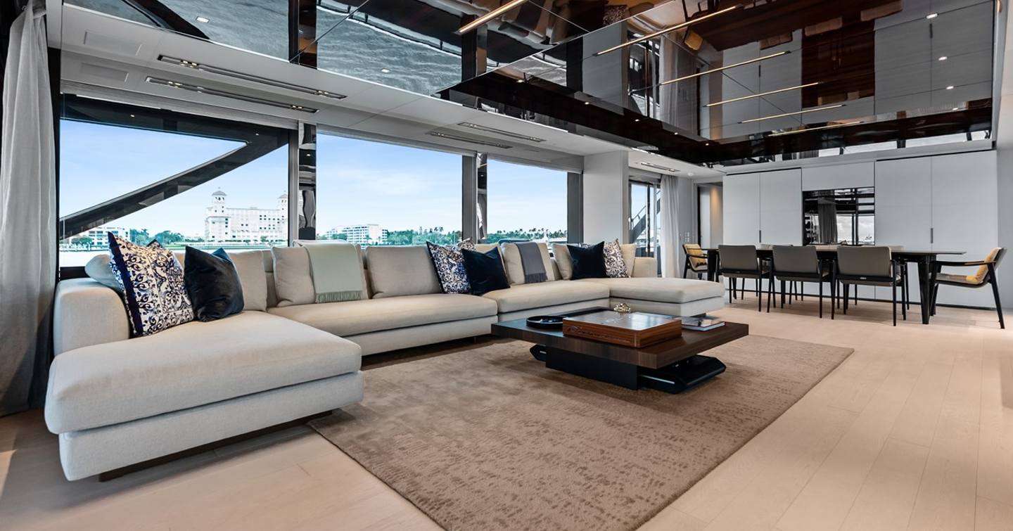 Superyacht Riva Royale main saloon with L-shaped seating and dining area 
