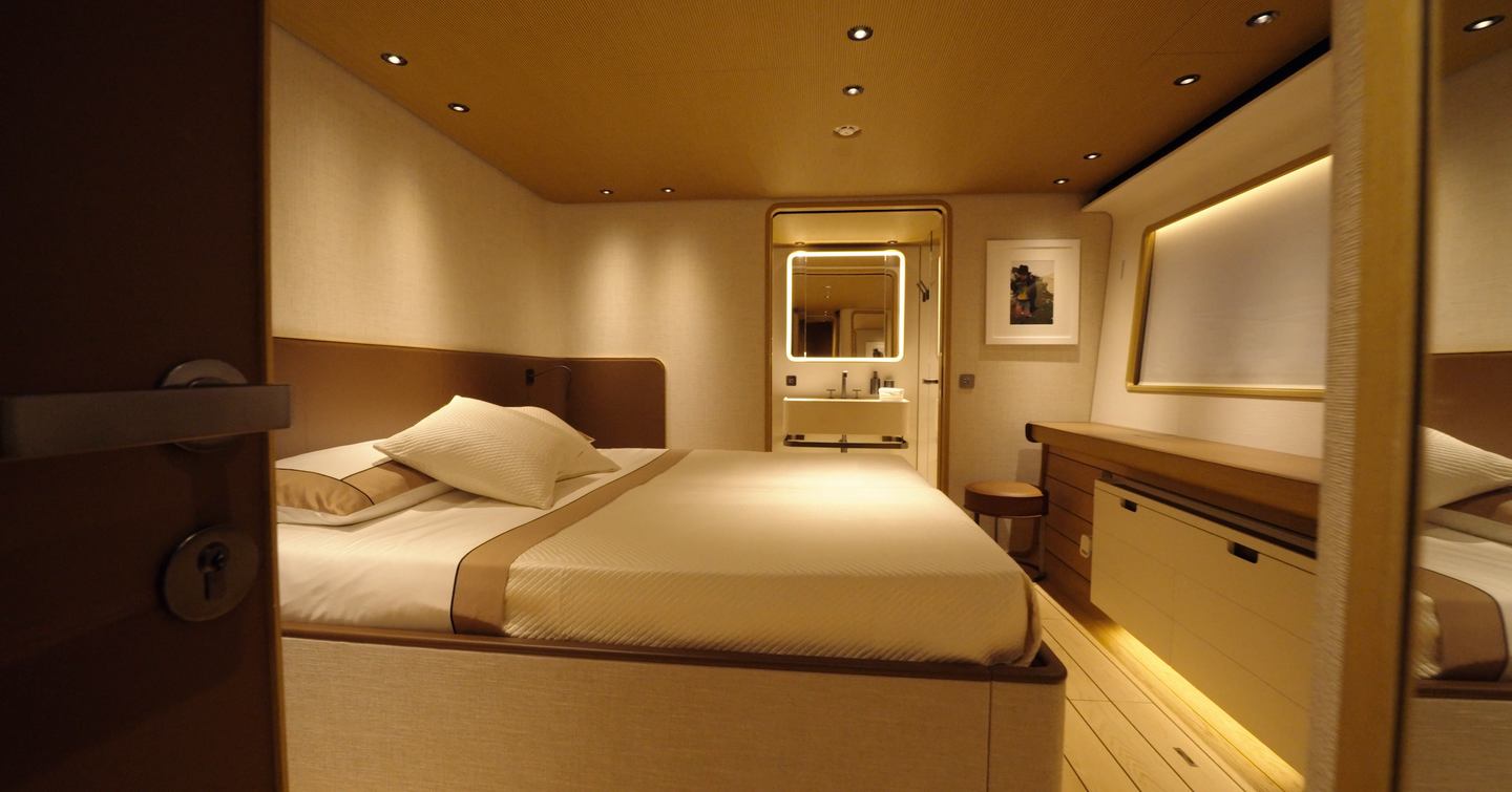 Custom Line Navetta 38 guest double cabin with ensuite bathroom, storage and warm interior finish on lower deck