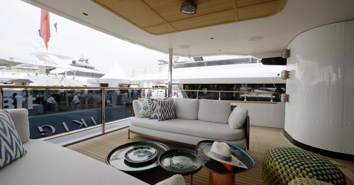 Sirena 118 main deck cockpit with side-on lounge seating and glass transom