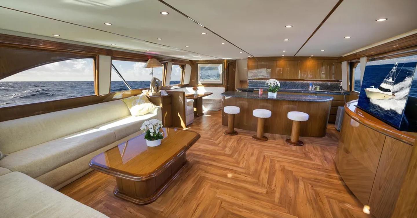 Viking 82C Sportsfisher yacht Monkey Business salooon with L-shaped sofa and marbled bar area 
