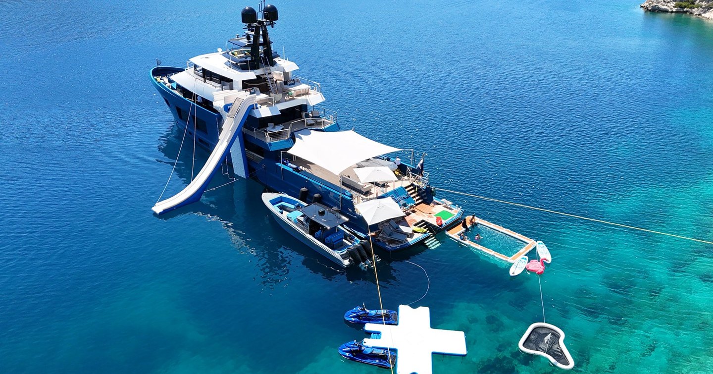 Motor yacht King Benji with toys deployed, including a slide, tenders and jetskis