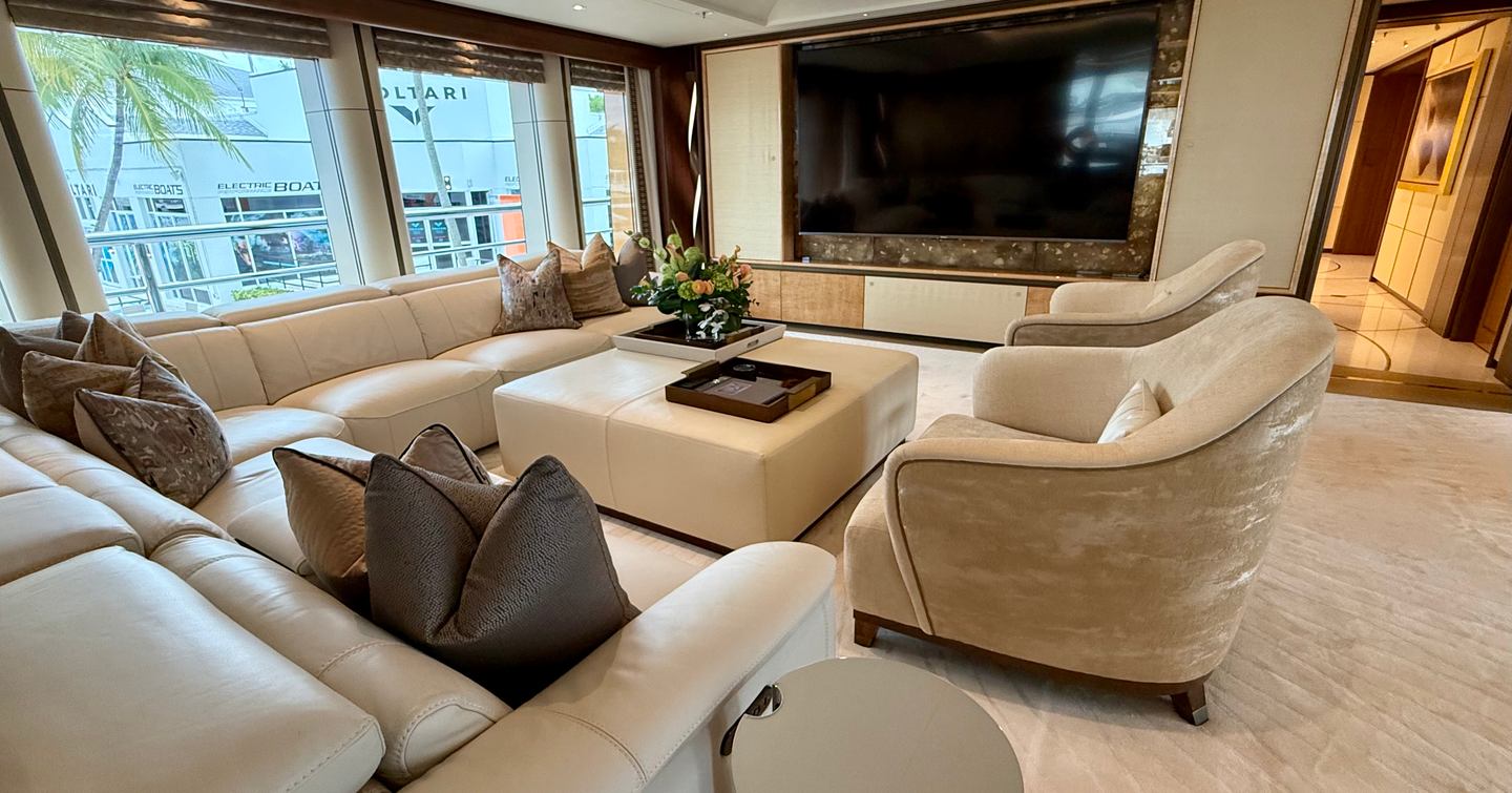 Owner’s deck lounge on the Amels 242 Casino Royale with sofas, large TV wall and panoramic windows.